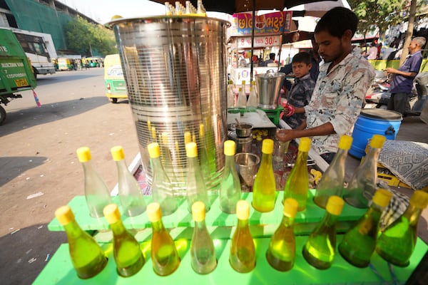 Mukesh Patni makes lime juice at his stall in Ahmedabad, India, Wednesday, April 2, 2025. (AP Photo/Ajit Solanki)