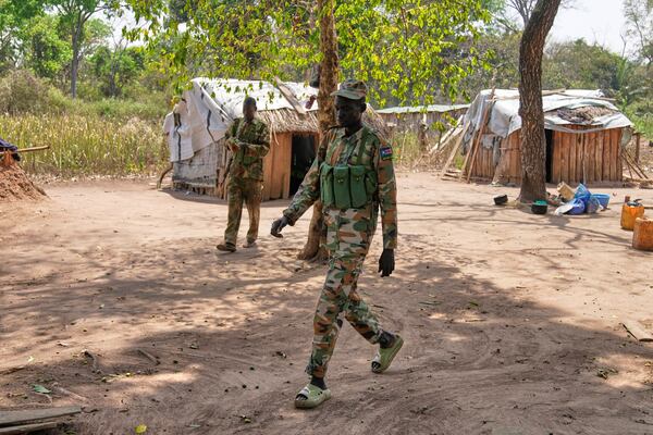 Soldiers walk around their outpost near Nzara, South Sudan on Saturday, Feb. 15, 2025. (AP Photo/Brian Inganga)