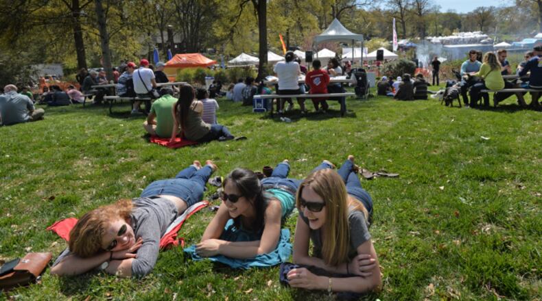 Festival goers (from left) Melissa Tinling, Kimberly Vuong and Isabelle Hotchings chat as they lay down and enjoy live music during The Festival on Ponce at Olmsted Linear Park on Saturday, April 5, 2014.