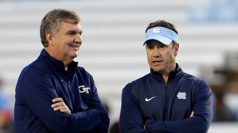 Georgia Tech coach Paul Johnson, left, and North Carolina coach Larry Fedora talk prior to an NCAA college football game in Chapel Hill, N.C., Saturday, Oct. 18, 2014. (AP Photo/Gerry Broome)