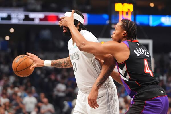 Dallas Mavericks forward Anthony Davis (3) has his face covered by Toronto Raptors' Scottie Barnes (4) as he handles the ball in the first half of an NBA basketball game in Dallas, Friday, April 11, 2025. (AP Photo/LM Otero)
