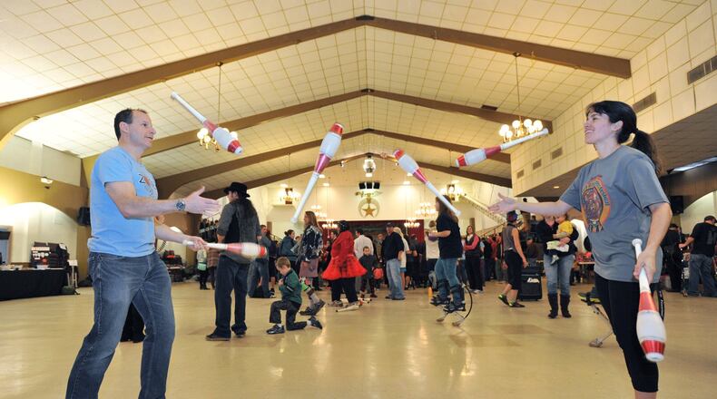 In this file photo from 2014, Neil Jordaan (left) and Heather Marriott practice “passing pins” during the annual Groundhog Day Jugglers Festival at the Yaarab Shrine Center in Atlanta. This year’s event will be held Jan 25-27. HYOSUB SHIN / HSHIN@AJC.COM