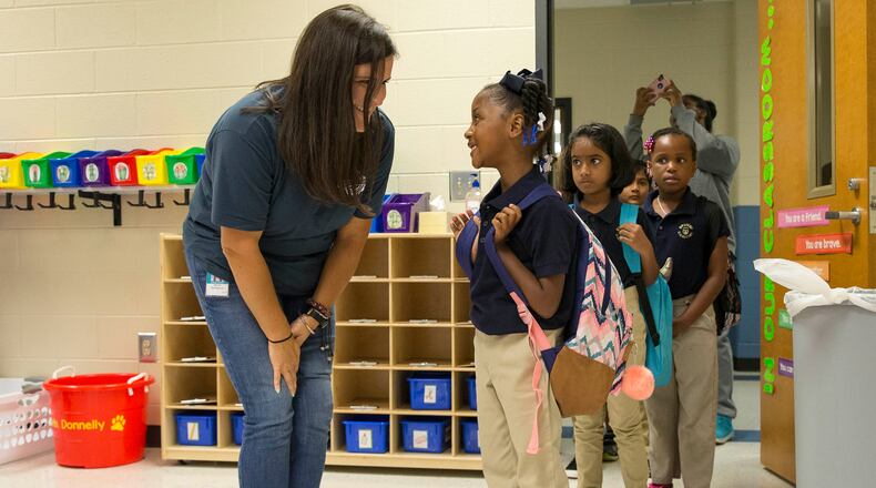 Second grade teacher Megan Donnelly (left) greets Aniya Bowden (right) during the first day of school at Brumby Elementary School in Marietta, Wednesday, Aug. 1, 2018.