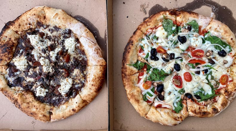 Here are two takeout pizzas from Phew’s Pies: the oxtail-ricotta and the veggie. Wendell Brock for The Atlanta Journal-Constitution