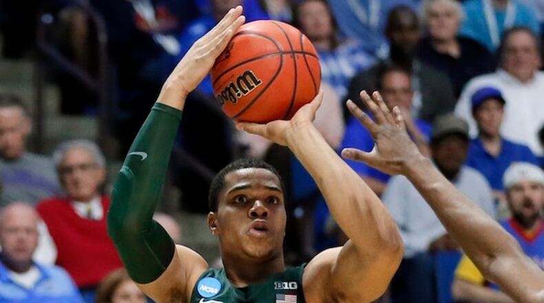 Michigan State guard Miles Bridges (22) attempts a three-point basket over Kansas' Josh Jackson (11) in the first half of a second-round game in the men's NCAA college basketball tournament in Tulsa, Okla., Sunday, March 19, 2017. (AP Photo/Tony Gutierrez)