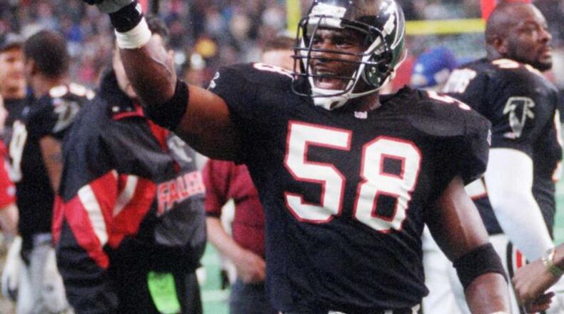 Falcons linebacker Jessie Tuggle points to the crowd after coming up with a huge interception in 1995. (AJC file photo)