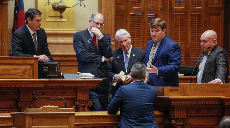 March 16, 2020 - Atlanta - Senate members and staff confer before the vote. Georgia lawmakers gathered in an extraordinary special session on Monday and voted to grant Gov. Brian Kemp sweeping new powers to respond to the coronavirus pandemic. It's the first time in state history a governor has declared a public health emergency, and Kemp cast it as essential to deploy all available resources to contain a disease that's sickened dozens of Georgians and has killed one. Bob Andres / robert.andres@ajc.com