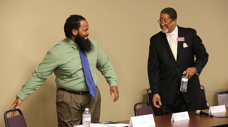 Mayoral candidates Douglas Favors (left) and Jason Lary arrive for a candidate forum for the city of Stonecrest at Salem Bible Church on Tuesday. Charles Hill, who is also running for mayor, was not present. Curtis Compton / ccompton@ajc.com
