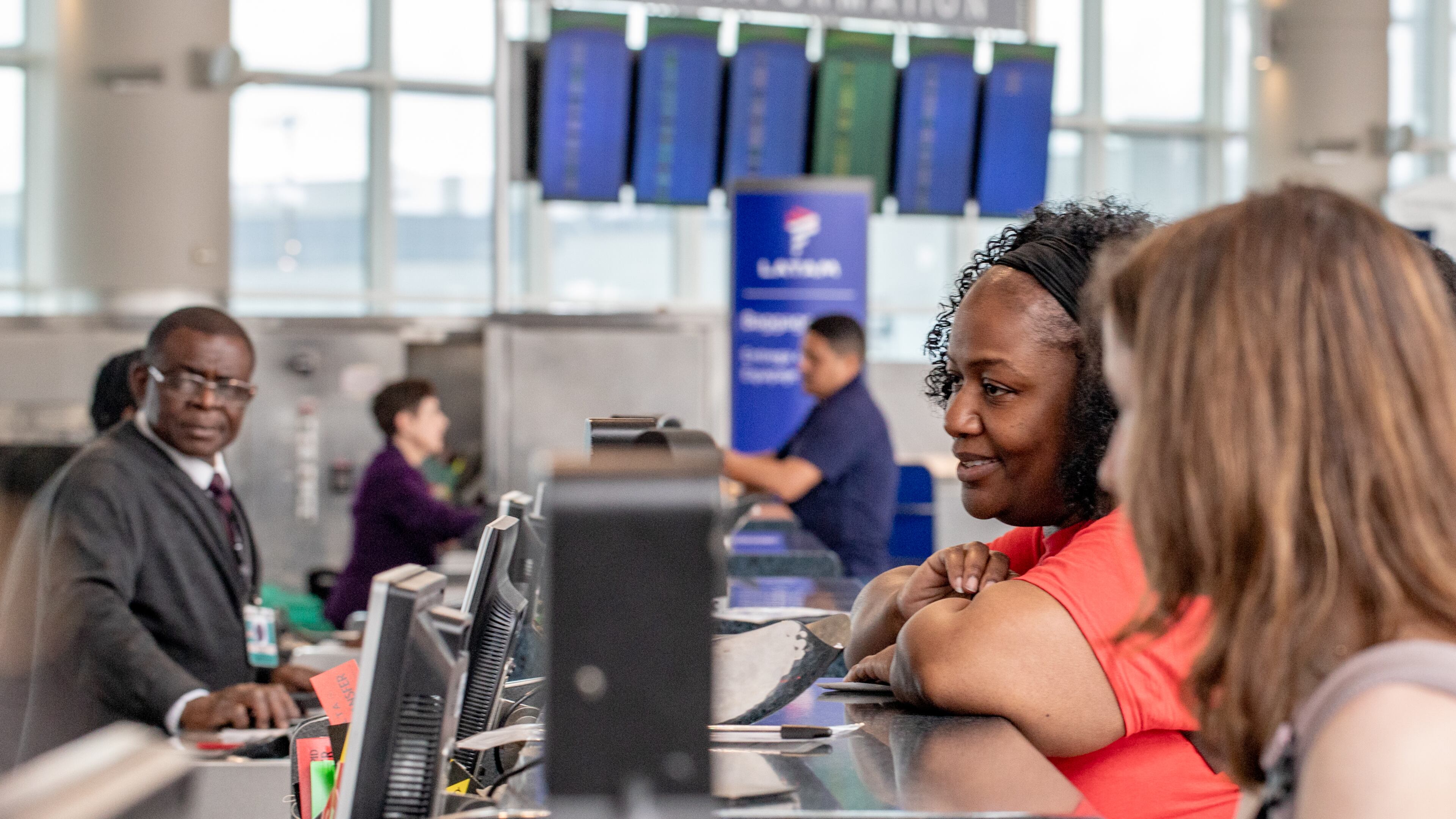 Stephanie Jones, Atlanta Public Schools leader, gets her boarding pass at the International counter at Hartsfield-Jackson Atlanta International Airport on April 5, 2025. (Jenni Girtman for The Atlanta Journal-Constitution)
