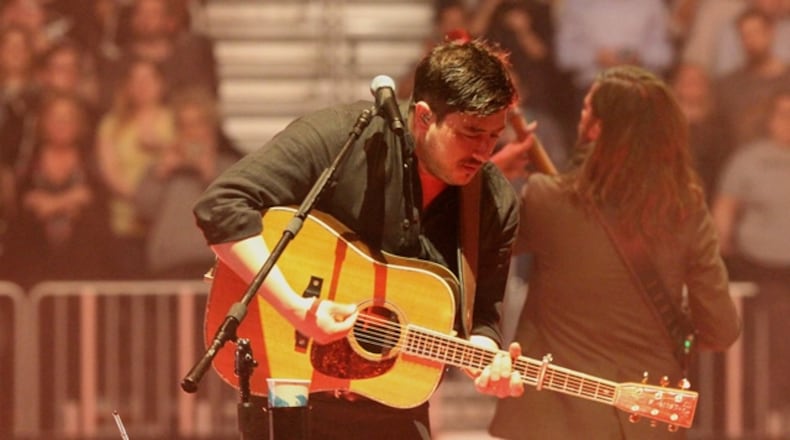 Marcus Mumford leans into a song during the sold-out March 20 Mumford & Sons concert at State Farm Arena. Photo: Melissa Ruggieri/Atlanta Journal-Constitution