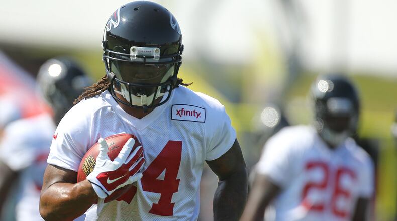 073115 FLOWERY BRANCH: Falcons running back Tevin Coleman (right) looks on as Devonta Freeman runs a drill on the first day of training camp on Friday, July 31, 2015, in Flowery Branch. Curtis Compton / ccompton@ajc.com
