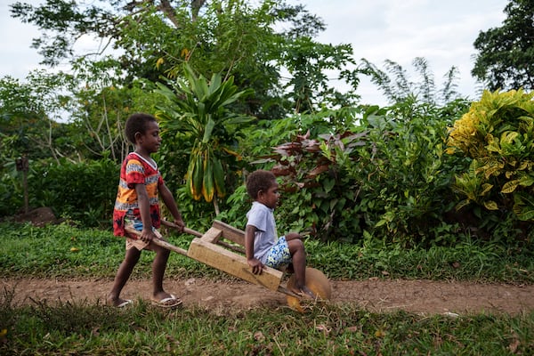 Children play on Pele Island, Vanuatu, Thursday, July 17, 2025. (AP Photo/Annika Hammerschlag)