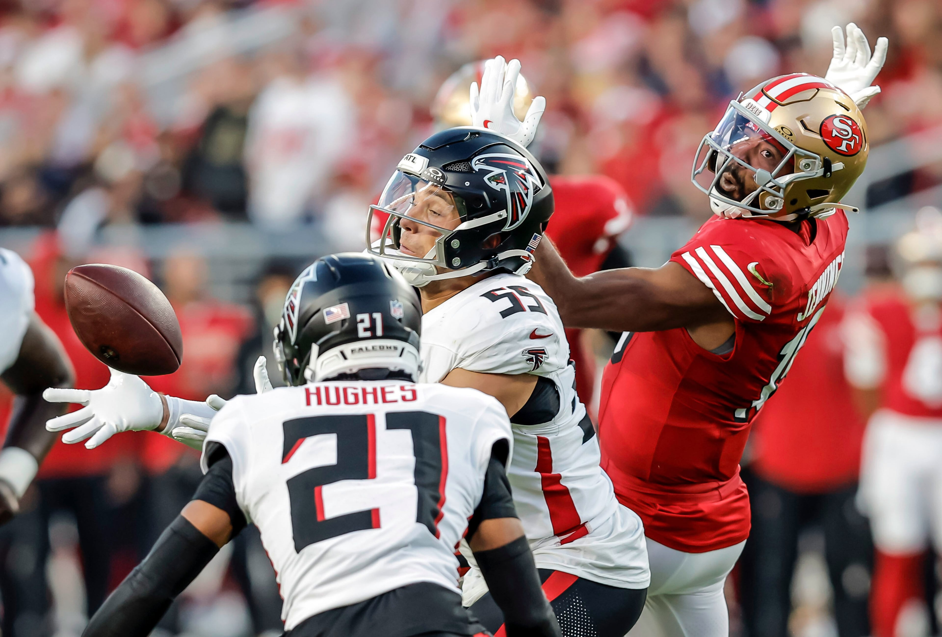 The Falcons' Kaden Elliss (center) reaches to intercept a ball bobbled by the 49ers' Jauan Jennings (right) on Sunday, Oct. 19, 2025, at Levi's Stadium in Santa Clara, Calif. (Carlos Avila Gonzalez/San Francisco Chronicle via AP)