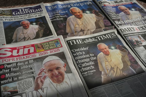 Newspapers with the front page of the late Pope Francis are seen in London, Tuesday, April 22, 2025. (AP Photo/Kin Cheung)