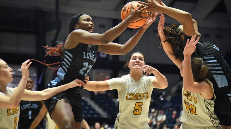 March 11, 2022 Macon - Lovejoy's La'nya Foster (23) and Lovejoy's Layla Hood (right) grab a rebound during the 2022 GHSA State Basketball Class AAAAAA Girls Championship game at the Macon Centreplex in Macon on Friday, March 11, 2022. Lovejoy won 54-38 over Sequoyah. (Hyosub Shin / Hyosub.Shin@ajc.com)