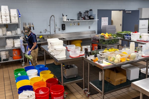 Animal nutrition tech Chandlar Carlile prepares fruits and vegetables for animals at Zoo Atlanta in Atlanta on Tuesday, July 1, 2025. (Arvin Temkar/AJC)