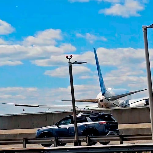 FILE - A United Airlines plane is seen in a still image taken from video after hitting a light pole on the New Jersey Turnpike as it lands at Newark Liberty International Airport, Sunday, May 3, 2026. (Patrick Oyulu, via AP)