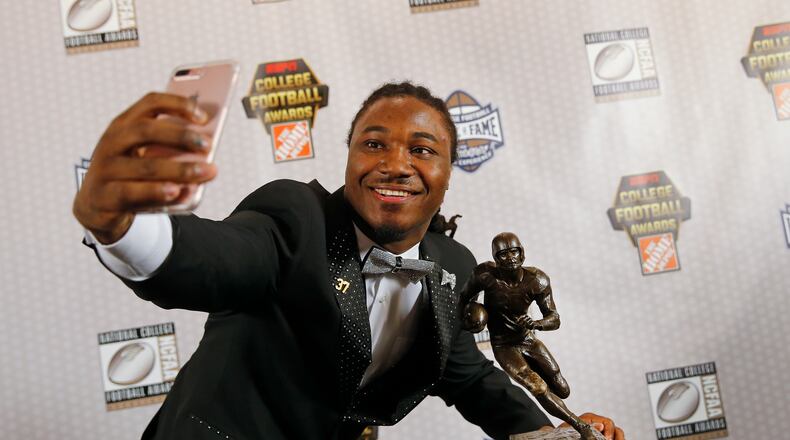 Texas running back D'Onta Foreman takes a selfie with the Doak Walker Award after winning it for being the nation's premier running back Thursday, Dec. 8, 2016, in Atlanta. (AP Photo/John Bazemore)