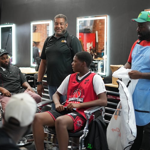 Khalil Thompson, center, co-founder of Win With Black Men, leads a discussion at Philly Cuts barber shop in Philadelphia, Friday, Aug. 21, 2026. (AP Photo/Matt Rourke)