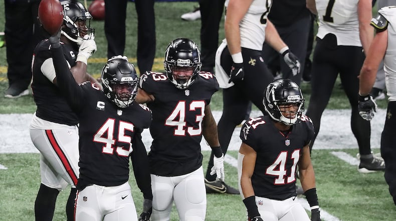 120620 ATLANTA: Atlanta Falcons Deion Jones (from left) comes up with the fumble recovery by Saints quarterback Taysom Hill with Mykal Walker and Sharrod Neasman during the 4th quarter in a NFL football game on Sunday, Dec. 6, 2020, in Atlanta. “Curtis Compton / Curtis.Compton@ajc.com”