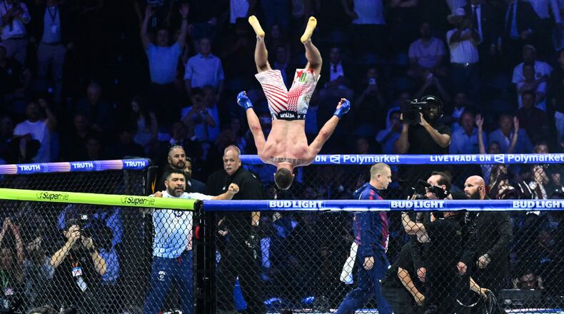 Justin Gaethje does a flip as he celebrates after defeating Ilia Topuria in a lightweight title bout during UFC Freedom 250 on the South Lawn of the White House, Monday, June 15, 2026, in Washington. (Saul Loeb/Pool Photo via AP)