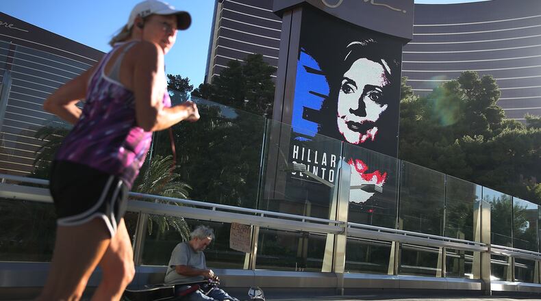 LAS VEGAS, NV - OCTOBER 12: Michael McLean sets up to play his guitar for money near a billboard showing a picture of Democratic Presidential candidate Hillary Clinton advertising the upcoming Democratic Presidential debate at the Wynn Las Vegas resort and casino on October 12, 2015 in Las Vegas, Nevada. The debate is scheduled for oCTOBER 13, and is the first debate for the Democratic presidential contenders. (Photo by Joe Raedle/Getty Images)
