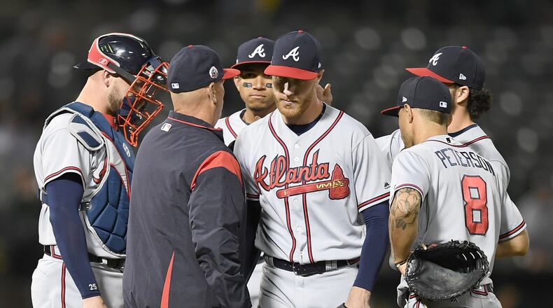 Manager Brian Snitker of the Atlanta Braves takes the ball from starting pitcher Mike Foltynewicz #26 taking Foltynewicz out of the game against the Oakland Athletics in the bottom of the ninth inning at Oakland Alameda Coliseum on June 30, 2017 in Oakland, California. (Photo by Thearon W. Henderson/Getty Images)