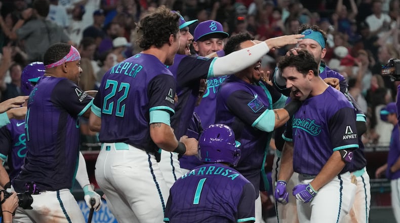 Arizona Diamondbacks' Ryan Waldschmidt celebrates with teammates after hitting a two-run walk off home run against the Los Angeles Dodgers during a baseball game, Friday, Aug 7, 2026, in Phoenix. (AP Photo/Rick Scuteri)