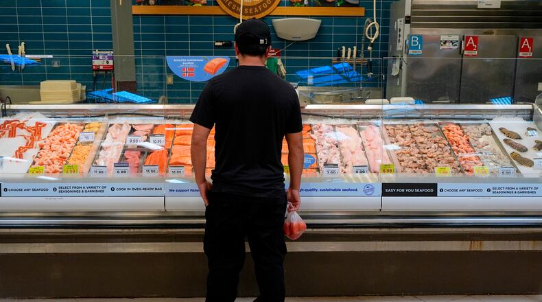 A person looks at the fresh fish at a grocery store Monday, May 11, 2026, in Nashville, Tenn. (AP Photo/George Walker IV)
