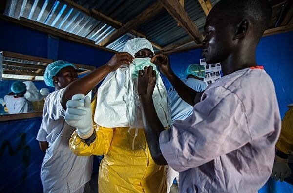 The David J. Sencer CDC Museum's Ebola exhibit depicts a Liberian nurse preparing to draw blood from patients at the Ebola Treatment Unit.