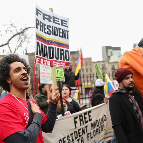 Demonstrators protest outside Manhattan federal court before a pre-trial hearing in former Venezuela President Nicolas Maduro's drug trafficking case, Thursday, March 26, 2026, in New York. (AP Photo/Heather Khalifa)