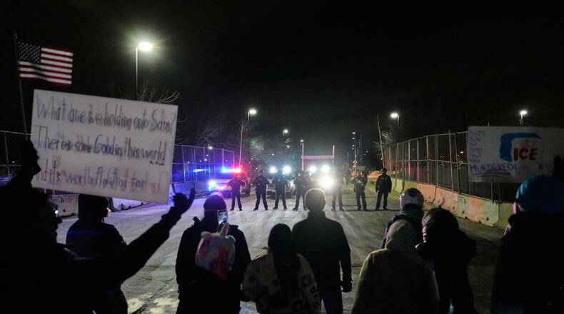 FILE - Federal immigration officers confront protesters outside Bishop Henry Whipple Federal Building in Minneapolis, on Thursday, Jan. 15, 2026. (AP Photo/Yuki Iwamura, File)