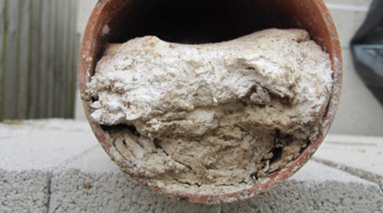 File photo depicts a DeKalb County sewer pipe clogged by paper towels and wipes. The city of Ball Ground reported more than $50,000 in damage to its sewer system caused by grease, shop towels and other foreign objects over the last three months. SPECIAL PHOTO / DEKALB COUNTY