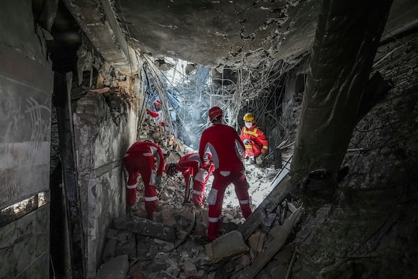 In this photo taken Tuesday, June 24, 2025, rescuers search through the rubble of a damaged section of Evin Prison following an Israeli strike the day before, in Tehran, Iran. (AP Photo/Mostafa Roudaki/Mizan News Agency)