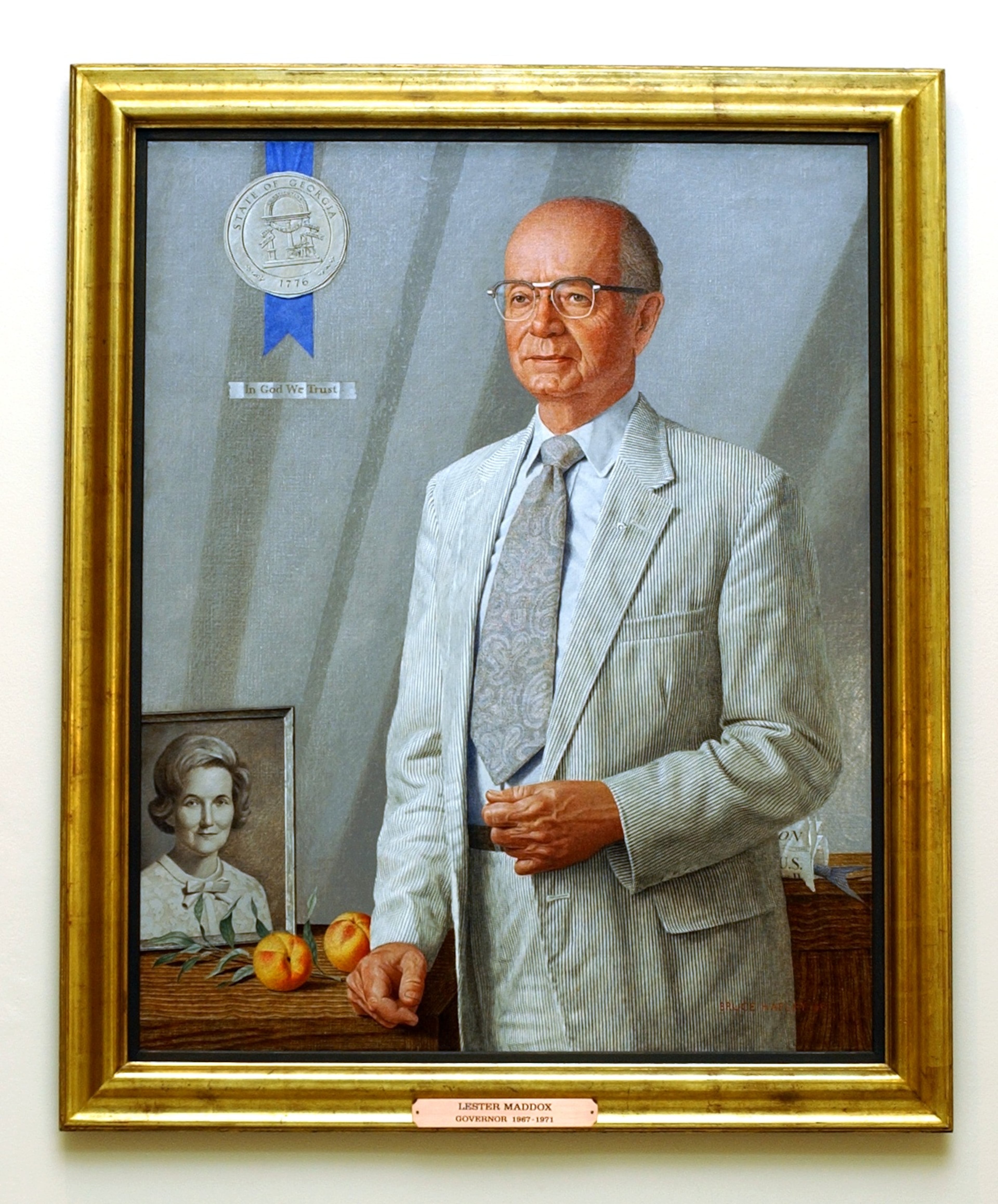In the portrait of former Gov. Lester Maddox that hangs in the state Capitol, the tail of a fish wrapped in a newspaper can be seen just below his elbow. (AJC file)