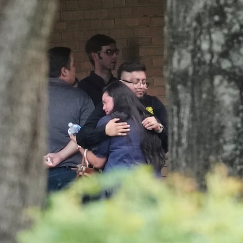 People hug outside the chapel during a public visitation for Lorenzo Salgado Araujo, who was shot and killed by an ICE officer, Thursday, July 16, 2026, in Houston. (AP Photo/David J. Phillip)