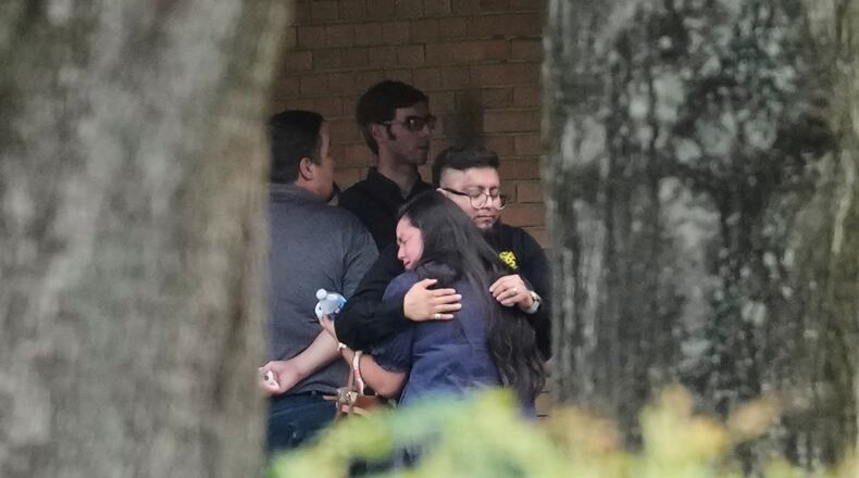 People hug outside the chapel during a public visitation for Lorenzo Salgado Araujo, who was shot and killed by an ICE officer, Thursday, July 16, 2026, in Houston. (AP Photo/David J. Phillip)