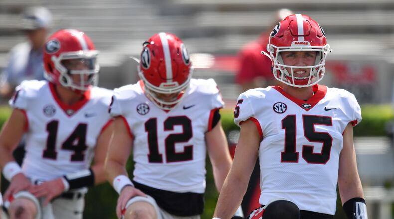 Georgia's quarterbacks (from left) Gunner Stockton (14), Brock Vandagriff (12) and Carson Beck (15) warm up before the G - Day game at Sanford Stadium, Saturday, April 15, 2023, in Athens. (Hyosub Shin / Hyosub.Shin@ajc.com)