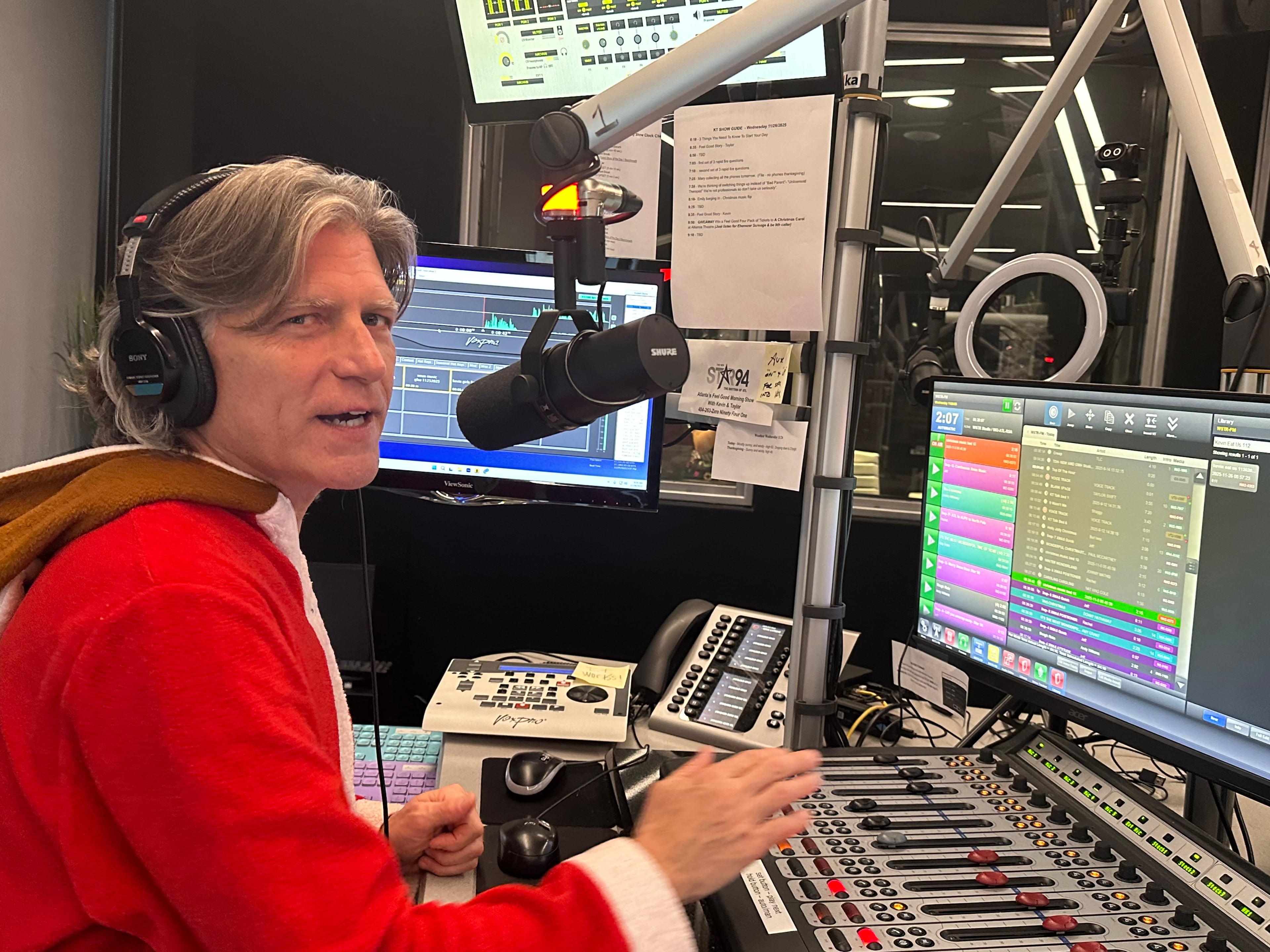 Kevin Avery works the boards on the day Star 94 switched to Christmas. (Rodney Ho/AJC)