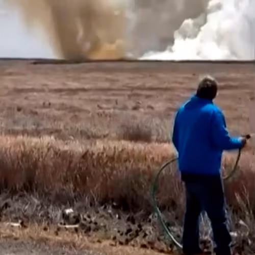 This still image taken from video shows a plume of smoke rises above the plain near Mountain Home Air Force Base, Idaho, where two Navy jets collided at an air show on Sunday. (Lisa Van Horne via AP)