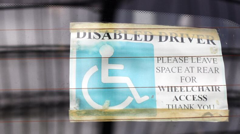 BATH, ENGLAND - FEBRUARY 16:  A sticker is displayed in the window of a car parked in a disabled car parking bay in a supermarket car park on February 16, 2011 in Bath, England. The government is currently considering a range of measures after it was revealed that the system - which allows badge holders free parking in many pay-and-display bays, at meters and on single- and double-yellow lines - was being widely abused. Currently, over 2.5million people qualify for the scheme, but research has shown that over a half of users are not entitled to use them and that there is widespread fraud and abuse involving the badges.  (Photo by Matt Cardy/Getty Images)