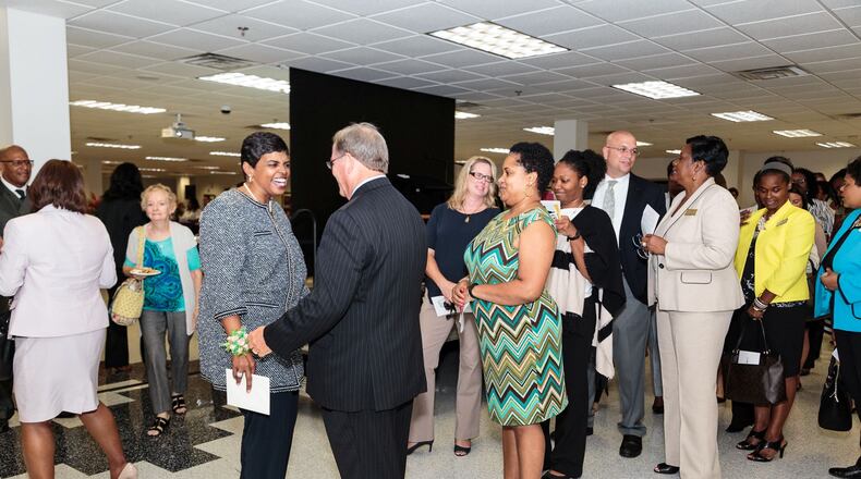 Frances Davis, in the gray top and black slacks, greets employees at a school district retirement celebration on Monday, September 26, 2016. PHOTO CREDIT: GWINNETT COUNTY PUBLIC SCHOOLS.