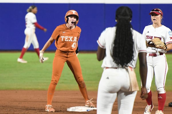 Texas' Leighann Goode celebrates a hit during the second game of the NCAA softball Women's College World Series finals against Texas Tech in Oklahoma City, Thursday, June 5, 2025. (AP Photo/Kyle Phillips)