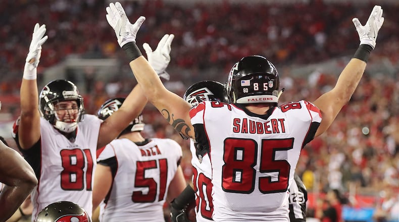 December 18, 2017 Tampa: Falcons tight ends Austin Hooper (left) and Eric Saubert signal the touchdown as Levine Toilolo recovers Devonta Freemans fumble into the endzone for a touchdown against the Buccaneers during the first half on the way to a 24-21 victory in a NFL football game on Monday, December 18, 2017, in Tampa. Curtis Compton/ccompton@ajc.com