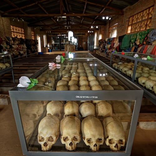 FILE - Skulls of some of those who were slaughtered as they sought refuge in a church sit in glass cases, kept as a memorial to the thousands who were killed in and around the Catholic church during the 1994 genocide, in Ntarama, Rwanda, April 5, 2019. (AP Photo/Ben Curtis, File)
