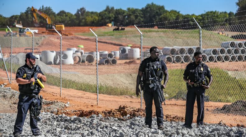 September 7, 2023 DeKalb County: Protesters gathered on Constitution Road (shown here) after five individuals were arrested Thursday morning, Sept. 7, 2023 at the site of Atlanta’s proposed public safety training center after chaining themselves to construction equipment in an effort to halt work. According to the Atlanta Police Department, the training center opponents broke into the construction site off Constitution Road around 9:30 a.m. Thursday. “Those 5 people have been taken into custody and we are working with the Georgia Bureau of Investigation regarding charges on these individuals,” the department said in a statement. About two dozen protesters also lined the site in unincorporated DeKalb County, east of Atlanta, in opposition to the 85-acre facility. They chanted “Cop City will never be built” as law enforcement officers amassed. The crowd called the effort “the people’s injunction” to halt construction. “We have tried to get justice in the courts, we have tried to get justice using our politicians, and unfortunately, they have betrayed and failed us,” said Mary Hooks, with the activist group Movement for Black Lives. “So when our government systems fail, that is when the people must stand up and take action.” The demonstration comes just days after more than 60 anti-training center activists were indicted on racketeering and other charges over the ongoing clash between the city and facility opponents. The indictment mainly focuses on the Defend the Atlanta Forest group, with prosecutors describing it as an “anti-government, anti-police, and anti-corporate extremist organization.” The indictment, handed up by a Fulton County grand jury, is being prosecuted by the Georgia Attorney General’s Office. “Anytime somebody puts their bodies on the line for the cause,” said Hooks, “it was worth the risk.” (John Spink / John.Spink@ajc.com)
