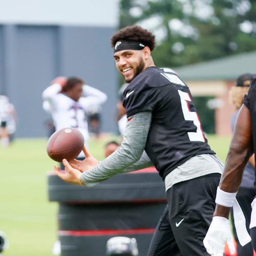 Atlanta Falcons wide receiver Drake London smiles with wide receiver Chris Blair while maneuvering the ball during minicamp at the team's training facility on Wednesday, June 11, 2025, in Flowery Branch, Ga. (Miguel Martinez/AJC)