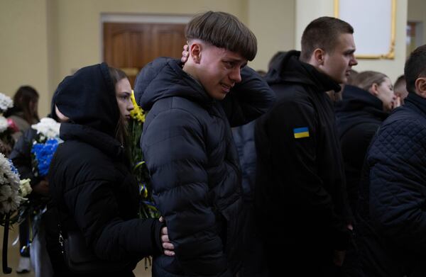 A man cries during farewell ceremony of Ukrainian soldier Oleksandr Samoilovich, 18, of 1st Separate Assault Regiment of Dmytro Kotsiubailo, in Slavuta, Ukraine, Friday, April 11, 2025. (AP Photo/Anna Donets)