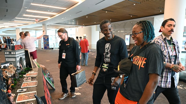 Toy designer David Vonner shares a smile with convention attendee Charmaine Edwards (right) during Toylanta, a toy and collectibles convention, at Gas South Convention Center, Saturday, March 29, 2025, in Duluth. Toy designer David Vonner is the guest-of-honor at Toylanta, a toy festival and convention held at Gas South Convention Center March 28-30. In addition to speaking on panels about his career experiences, the designer will debut new toy collections and plans to connect with toy enthusiasts. (Hyosub Shin / AJC)