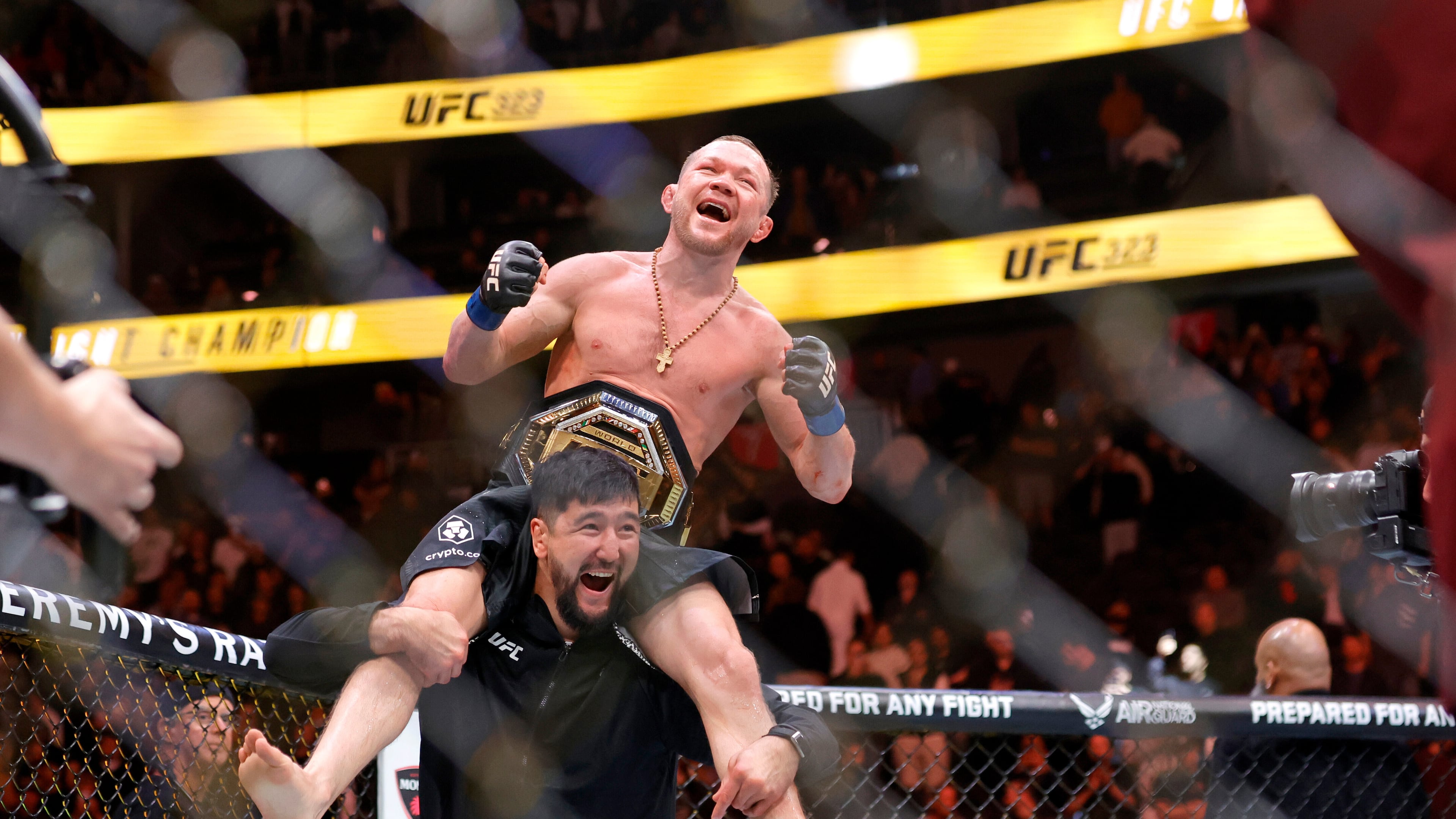 Petr Yan celebrates with a member of his team after defeating UFC bantamweight champion Merab Dvalishvili during UFC 323 Saturday, Dec. 6, 2025, in Las Vegas. (Steve Marcus/Las Vegas Sun via AP)